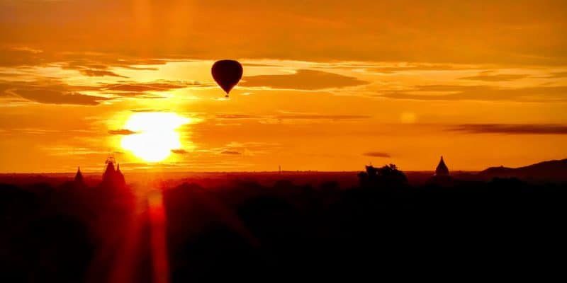 Hot Air Balloon Over Temple at Sunset